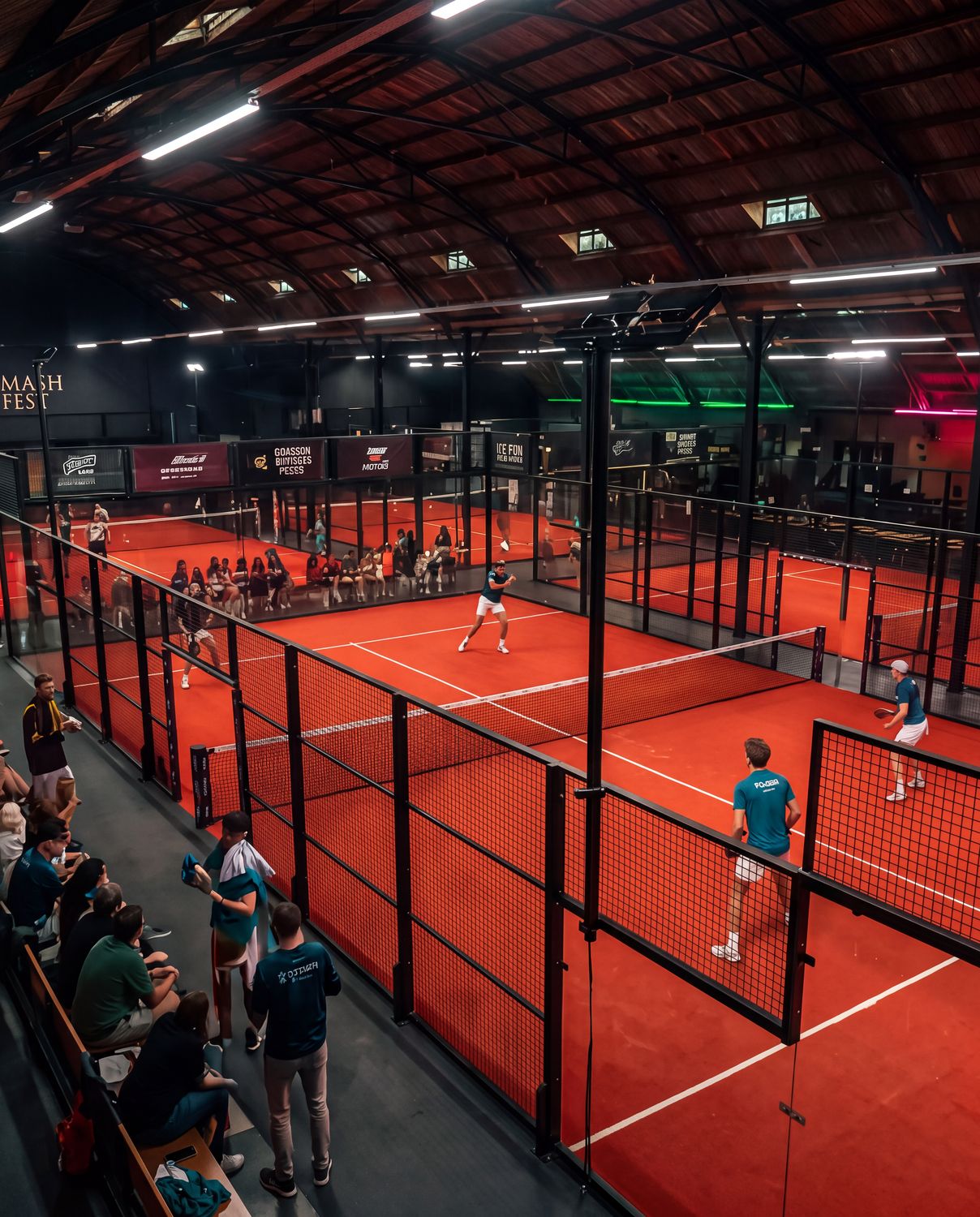 Overzicht van acht padelbanen met publiek